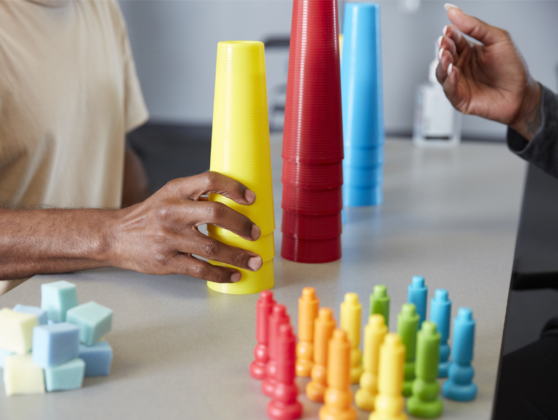 Patient preforming hand exercises for hand therapy