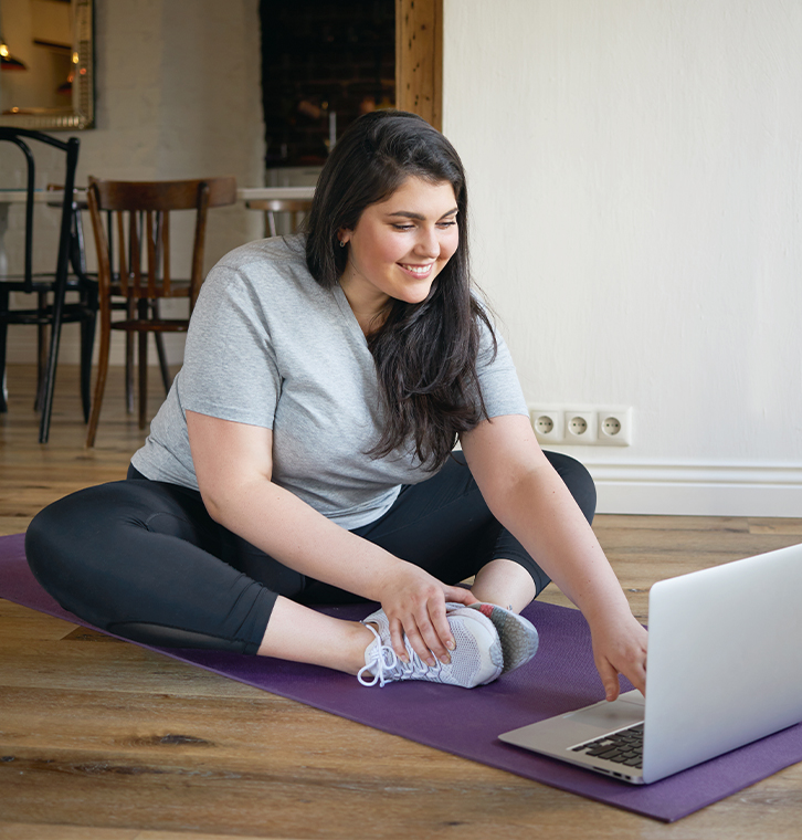 Woman completing online physical therapy from her home
