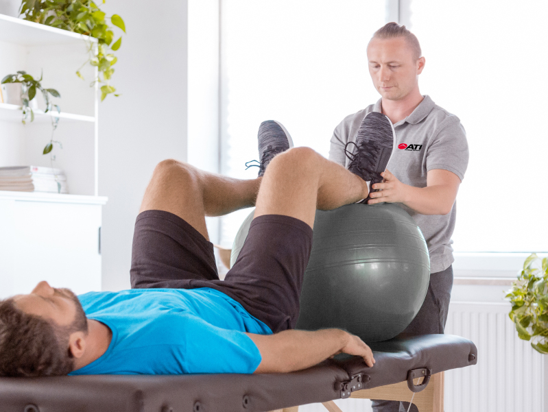 Men's pelvic health physical therapy session in progress.