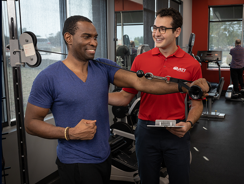 Man receiving physical therapy treatment from ATI